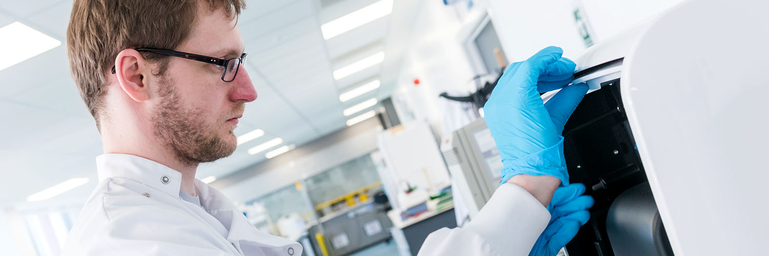A biomedical science masters student using equipment