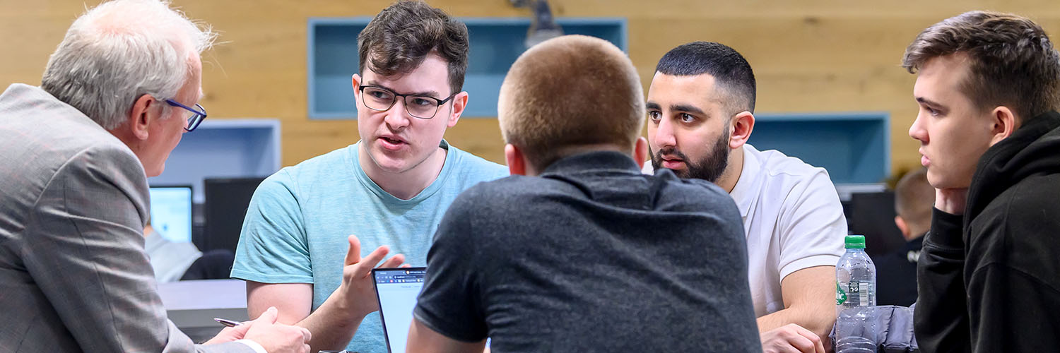 Cyber Security students talking with tutor
