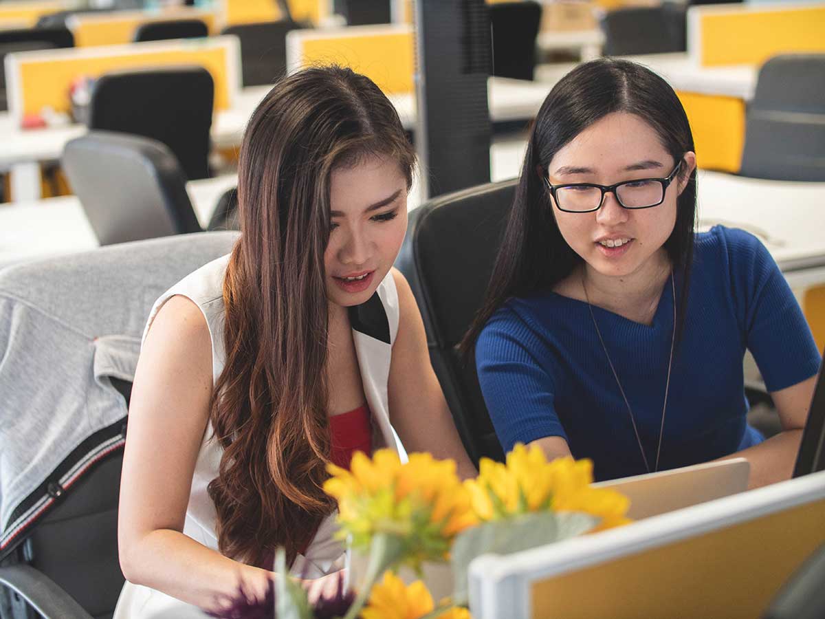 Two students working at a computer together