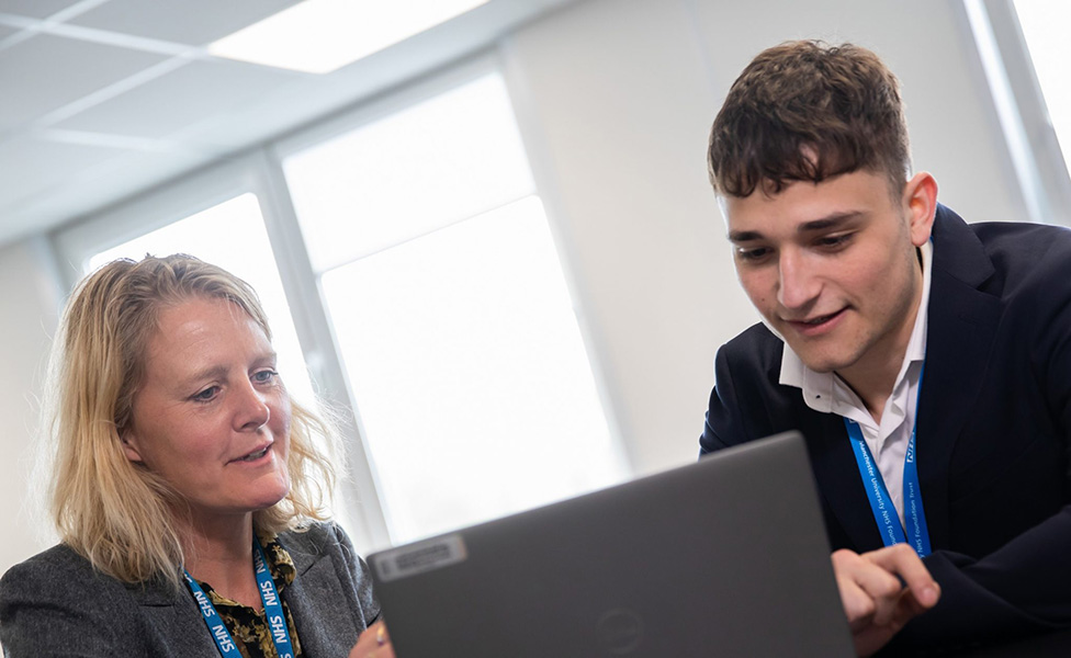 Accounting and finance student Harry Rosenberg sat in front of his laptop with his placement provider, Suzanne, sat next to him.