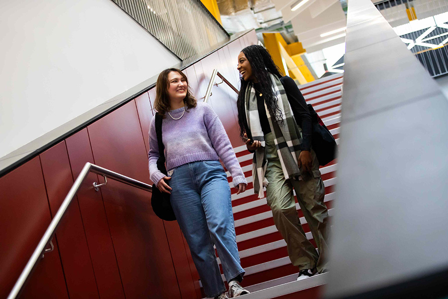Students on stairs in the Science, Engineering & Environment (SEE) Building, University of Salford