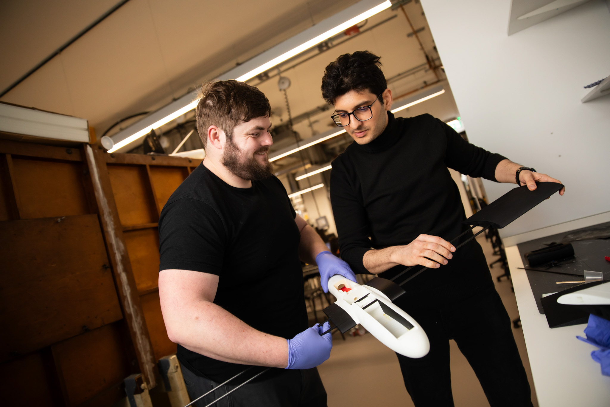 Aeronautical Engineering students working with a model airplane