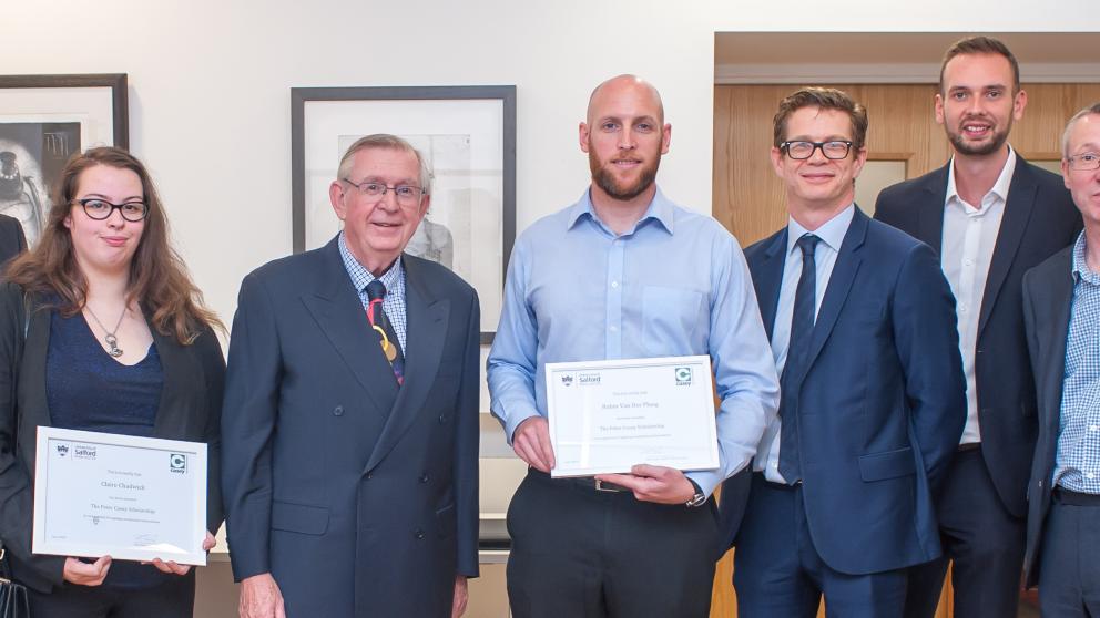 Peter Casey staff presenting two scholars with their certificates