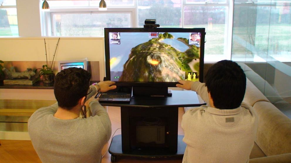 Two people using an interactive volcano game for BBC Learning, THINKlab, University of Salford