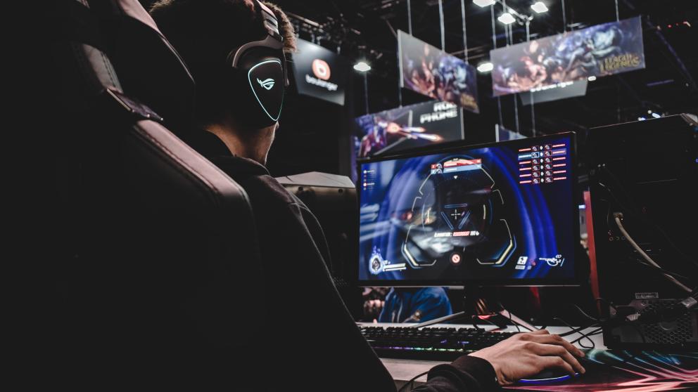 Student using a gaming workstation in the Esports Suite, Salford Business School