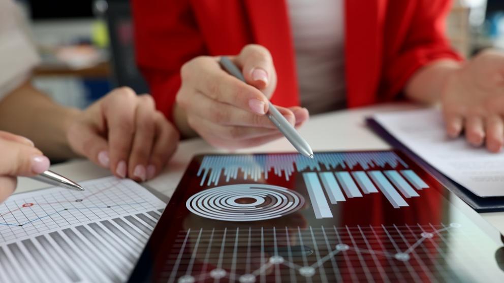 People looking at data charts on tablet