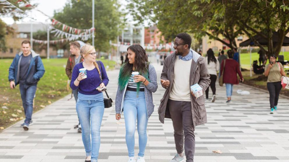 Students walking and talking on campus