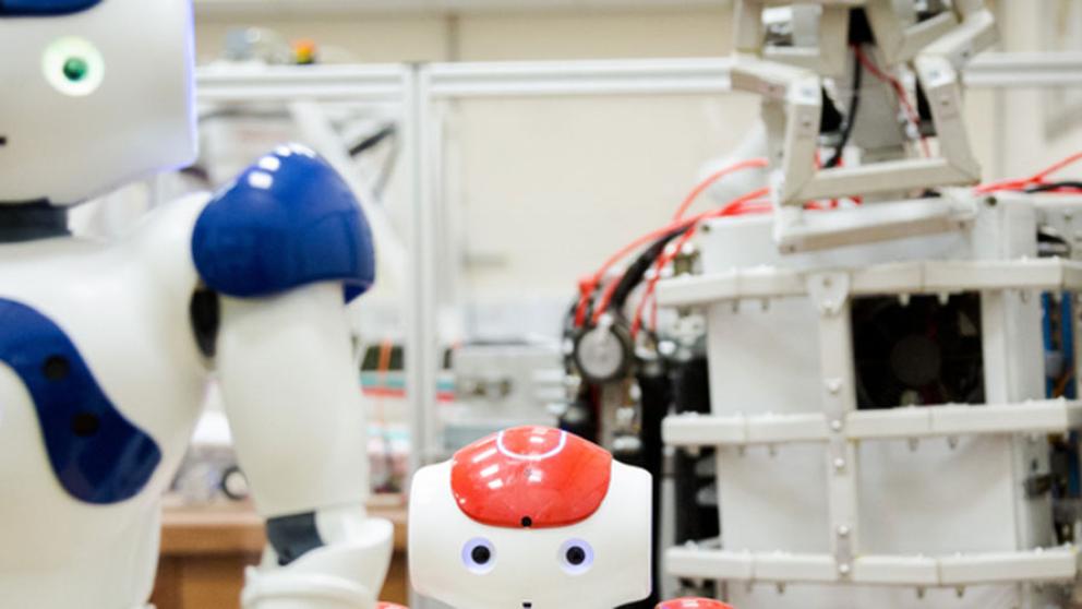 Two robots one blue slightly taller than a red robot