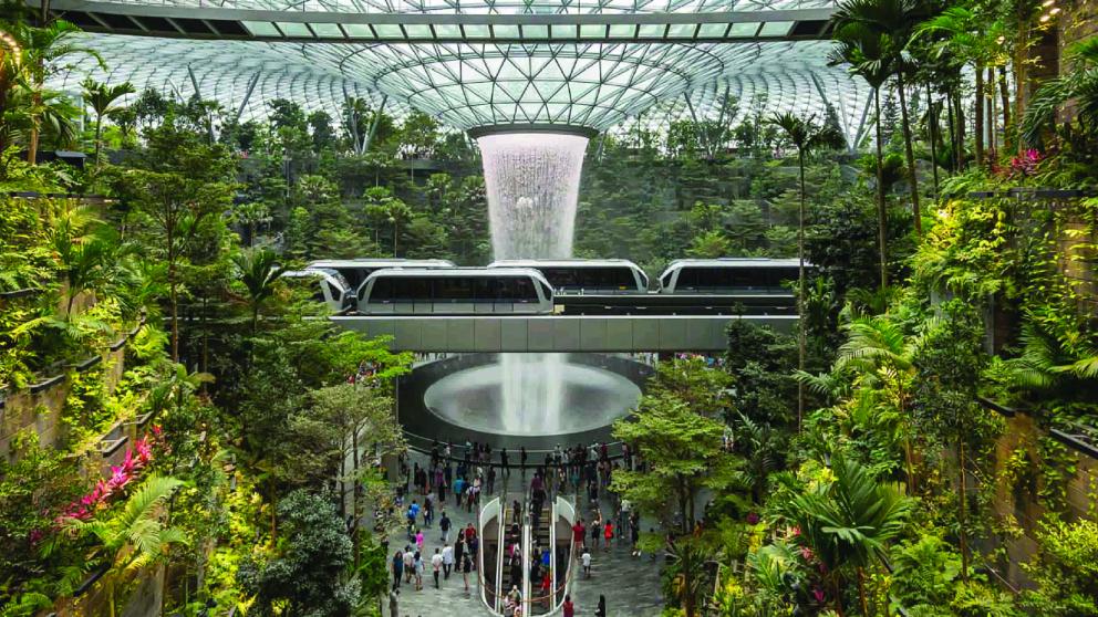 Futuristic transport hub with trains and greenery