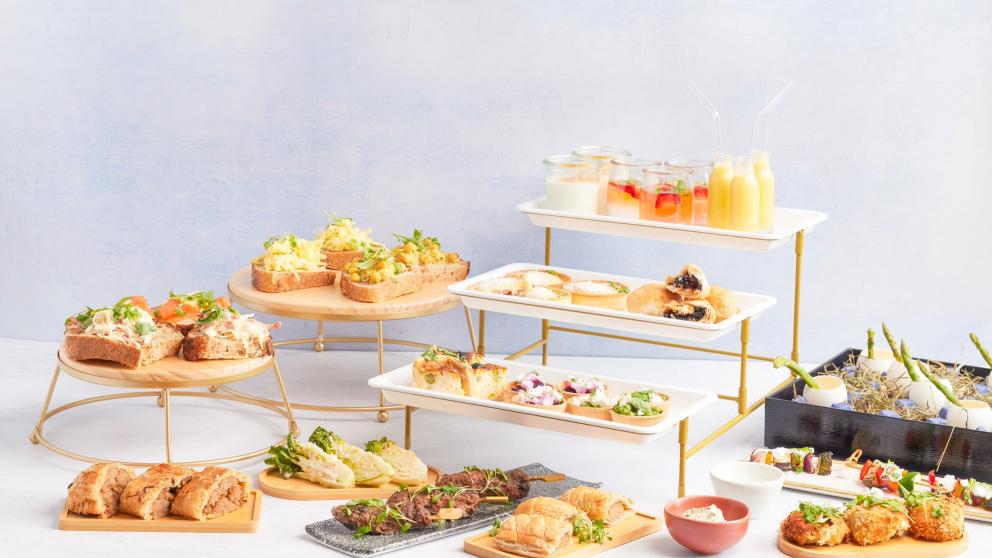 Hospitality buffet platter containing sandwiches, sausage rolls and tarts