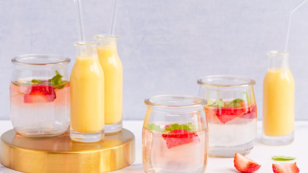Glasses of orange juice and strawberry water