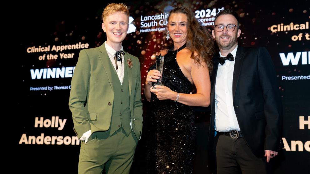 Holly Anderson receives an award from Owain Wyn Evans