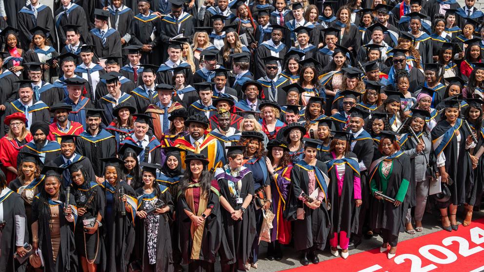 Graduates posing for a group photo after their graduation ceremony