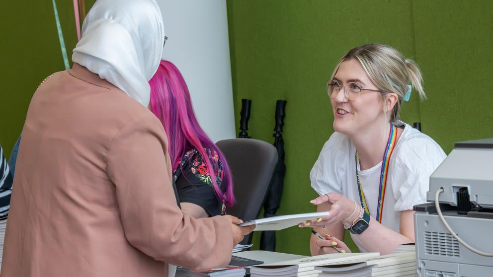 A student at the graduation ceremony check-in desk