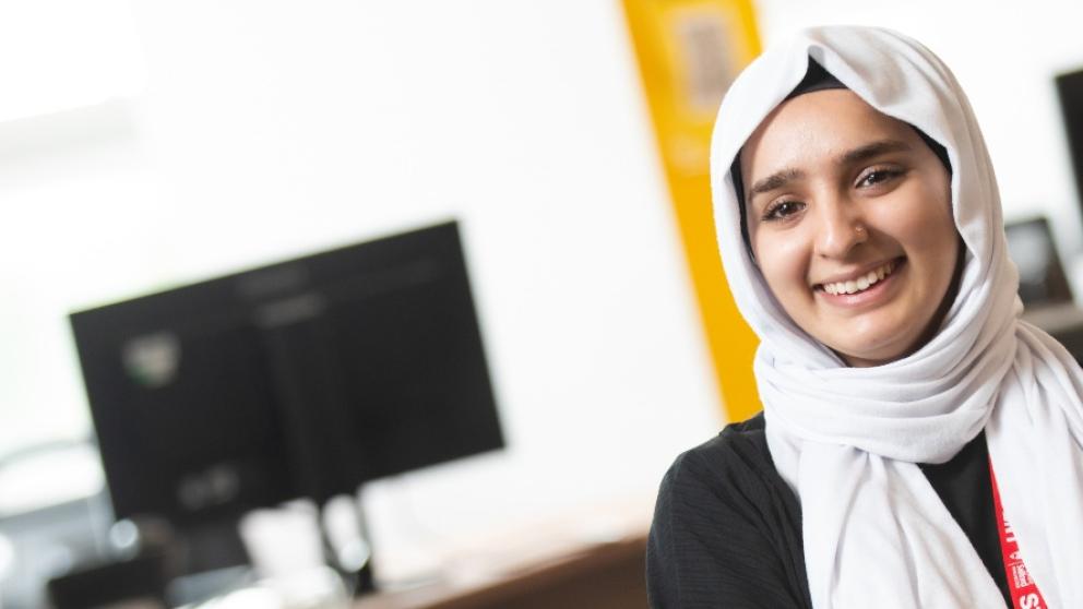 Student at the askUS help desk in University House, University of Salford