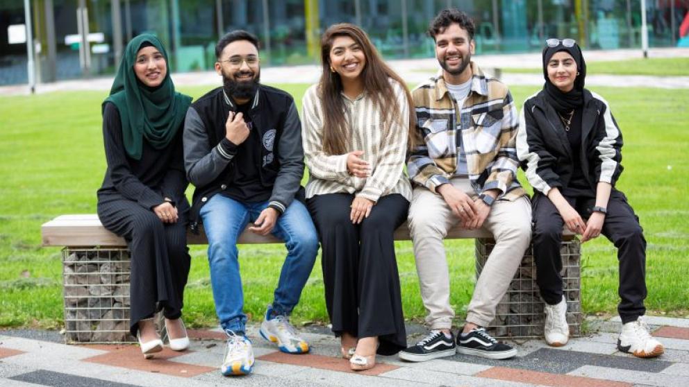 Five Student Union officers sat outside the Science, Engineering & Environment (SEE) Building, University of Salford
