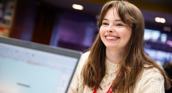 A student at the askUS counter in University House, University of Salford
