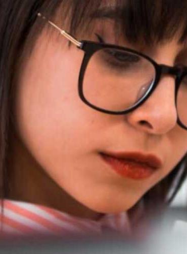 A student looks at books in the Library