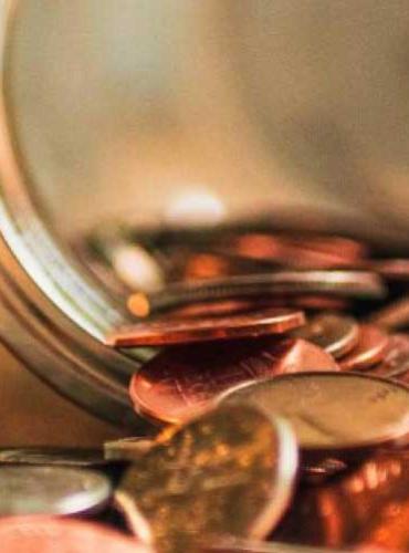 Coins spilling from a jar