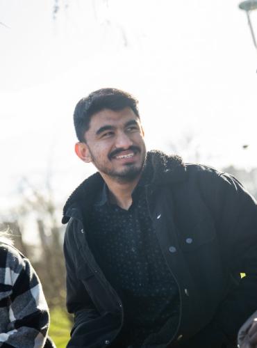 Sujan chatting with friends in Peel Park